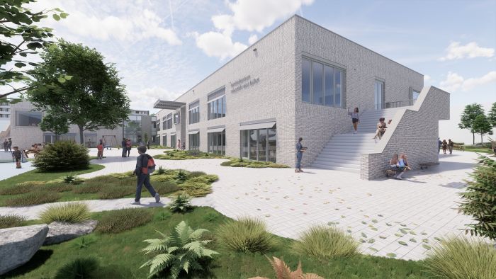 Kernkindcentrum Maastricht-West – impressie van licht bakstenen school met brede buitentrap, grote ramen en groen ingericht plein met beplanting
