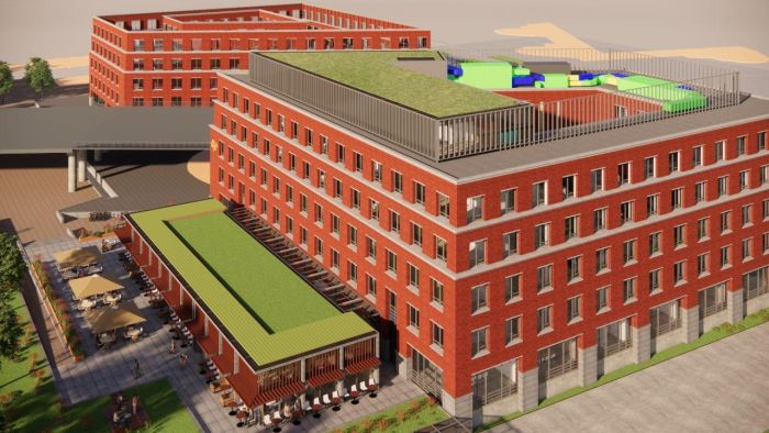 Impressie Van der Valk Maastricht-Maas met rode baksteen, dakterras en groene daken.