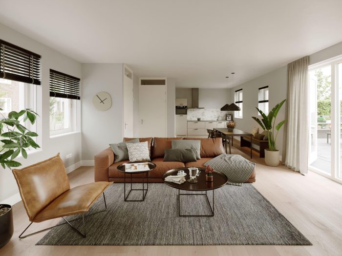 Nieuwbouw Nieuw Absbroek Geleen – moderne woonkamer met bruine leren bank, open keuken, eethoek, veel licht en schuifdeur naar tuin